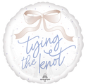 The Anagram/MD 18" Tying the Knot Foil Balloon features a round white design with a light pink bow, "tying the knot" in elegant blue script, and pastel dots across the background.
