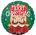 The Anagram/MD 18" Nutcracker Workshop Christmas Foil Balloon features a smiling cartoon nutcracker in red and green with gold details and “Merry Christmas” in bold white text above.