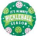 The 18" Pickleball Foil Balloon by Anagram/MD is round and green, featuring white and pink pickleballs with “It’s Always Pickleball Season” in bold white and yellow letters.
