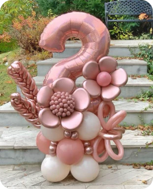 intricate balloon display in rose gold and white, with balloons made to look like various flowers, and wheat, with the number 2