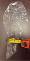 Clear plastic sheet on a wooden surface with a tape measure for scale.