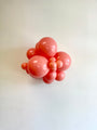 A cluster of Tuftex 5 Inch Tuftex Latex Balloons Designer Balloons in the shade “Poppy” is arranged against a plain white background.