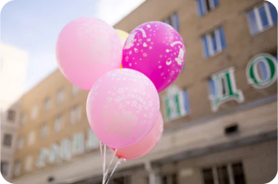 Pink latex balloons with an out of focus building in the background